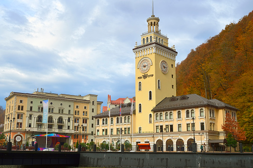 Rosa Khutor, Sochi, Russia, 11.01.2021. Town hall with a clock in a mountain village. Olympic town on the banks of the mountain river Mzymta in autumn