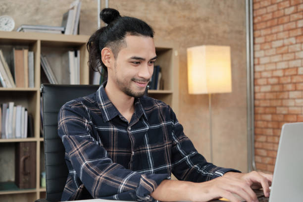istock Male worker works with laptop in casual creative office. 1363201393