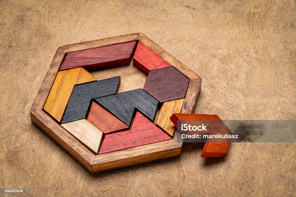 wooden hexagon tangram puzzle wooden hexagon tangram puzzle against textured handmade bark paper, brain teaser and fun game with multiple ways to solve Wood - Material Stock Photo