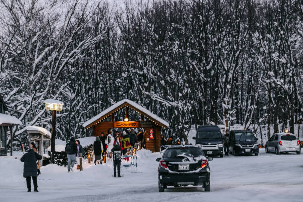 Furano, Japan - 4 January, 2020: Many car parked at Ningle Terrace on Furano city in winter. Soft focus, selective focus.