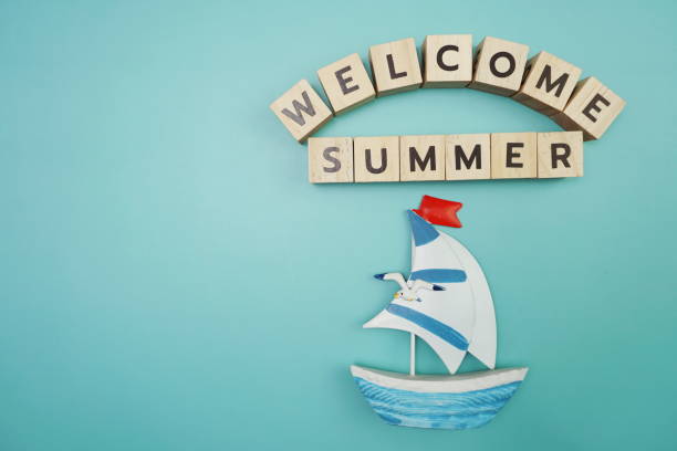 istock Welcome Summer message alphabet letter with sailboat on blue background 1363203933