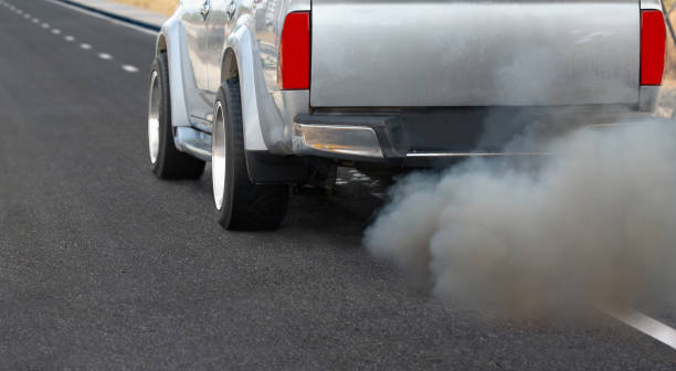 istock Air pollution from diesel vehicle exhaust pipe on road. 1363204902