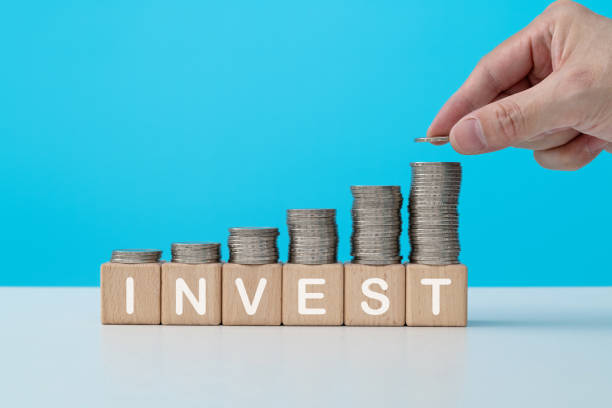 istock Stack of coins on word invest 1363206026