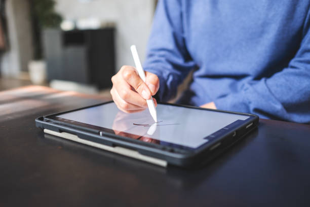 istock Closeup of a woman using smart pen technology for working and writing on digital tablet screen 1363206646