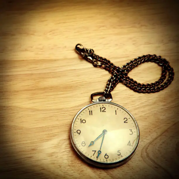 Vignetting Photo of Vintage Watch on the Wooden Background