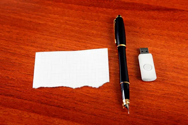 Empty Paper with the Pen and USB Drive on The Table