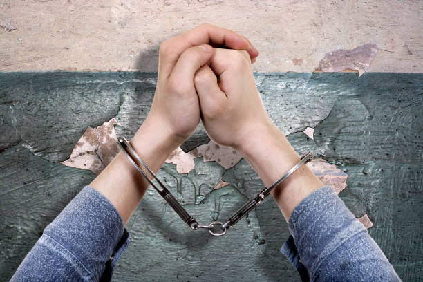 istock Handcuffs on the Hands closeup 1363206889