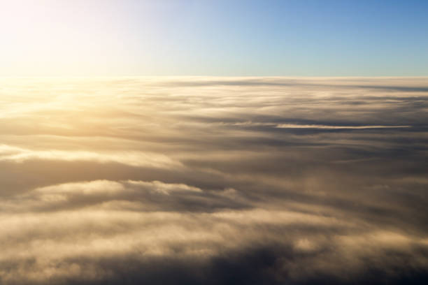 istock Clouds view from the window of an airplane in light morning. 1363209107