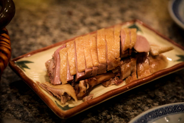 Christmas dinner in white contemporary kitchen. On the menu is roasted duck breast