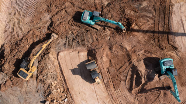 istock Construction site, Aerial top view road roller and loader excavator tractor and soil grade car earthmoving at work, Heavy equipment is grading the land, moving and flattening out red clay soil. 1363215087