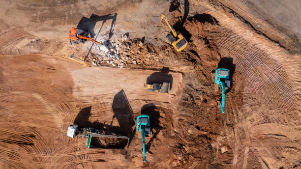 istock Construction site, Aerial top view road roller and loader excavator tractor and soil grade car earthmoving at work, Heavy equipment is grading the land, moving and flattening out red clay soil. 1363215091