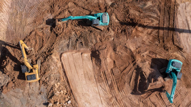 istock Construction site, Aerial top view road roller and loader excavator tractor and soil grade car earthmoving at work, Heavy equipment is grading the land, moving and flattening out red clay soil. 1363215097