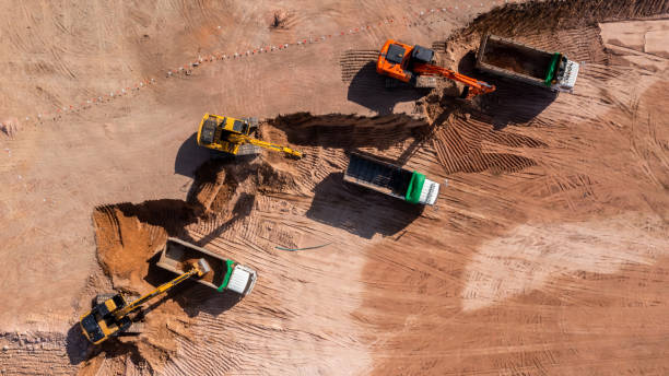istock Construction site, Aerial top view road roller and loader excavator tractor and soil grade car earthmoving at work, Heavy equipment is grading the land, moving and flattening out red clay soil. 1363215098