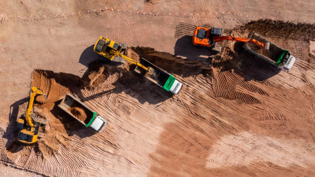 istock Construction site, Aerial top view road roller and loader excavator tractor and soil grade car earthmoving at work, Heavy equipment is grading the land, moving and flattening out red clay soil. 1363215099