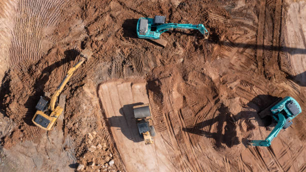istock Construction site, Aerial top view road roller and loader excavator tractor and soil grade car earthmoving at work, Heavy equipment is grading the land, moving and flattening out red clay soil. 1363215101