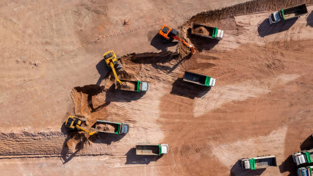 istock Construction site, Aerial top view road roller and loader excavator tractor and soil grade car earthmoving at work, Heavy equipment is grading the land, moving and flattening out red clay soil. 1363215102