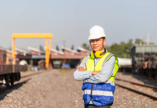 istock Worker man in hard hat with crossed arms, Engineer man working in cargo train platform 1363215243