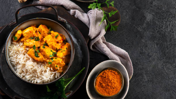 istock Indian butter chicken curry with basmati rice on dark background. 1363216863