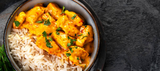 istock Indian butter chicken curry with basmati rice on dark background. 1363217469