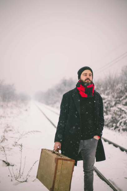 istock young man on railroad tracks 1363218124