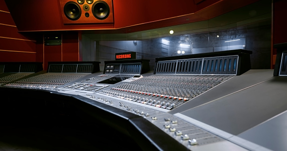Interior view of recording studio with mixing desk.