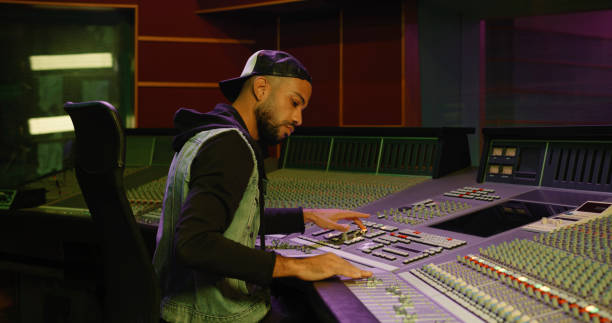istock Young man operating sound mixer in recording studio 1363223157