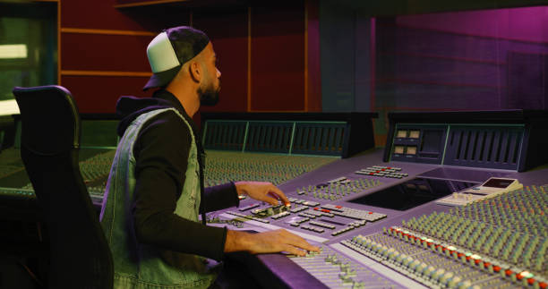 istock Young man operating sound mixer in recording studio 1363223374