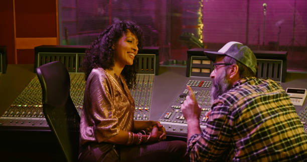 istock Female singer and composer talking in recording studio 1363223413