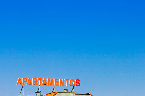 istock Apartments sign on building facade, clear sky background. 1363224559