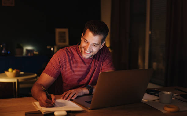 istock Smiling Businessman Working at Home at Night 1363227289