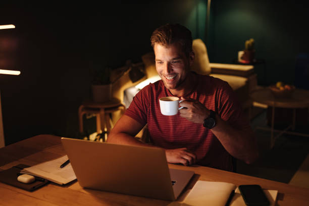 istock Happy Businessman Working on a Laptop Computer at Night 1363227290
