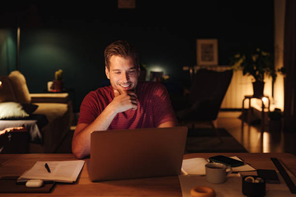 istock Happy Businessman Working on a Laptop Computer at Night 1363227294