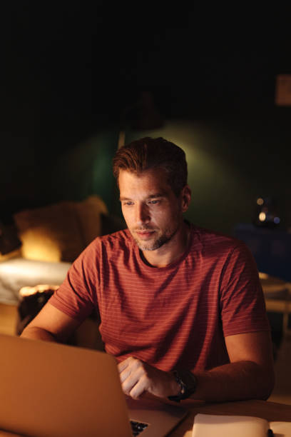 istock Serious Businessman Working on a Laptop Computer at Night 1363227297
