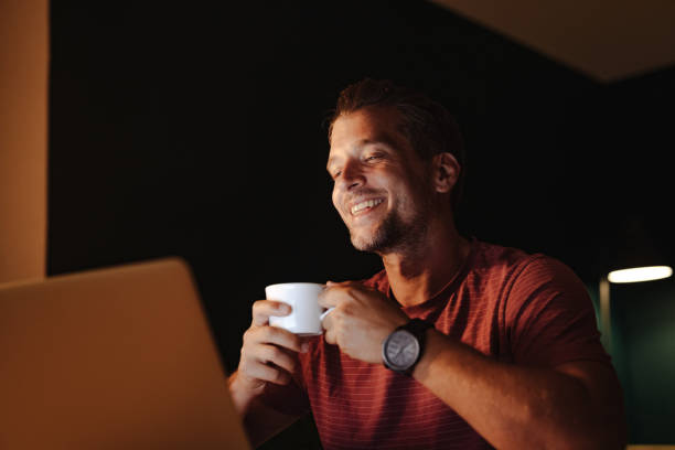 istock Happy Businessman Working on a Laptop Computer at Night 1363227303