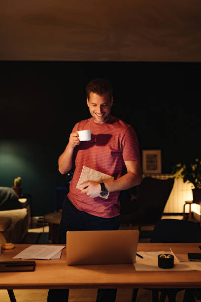 istock Smiling Businessman Working at Home at Night 1363227395