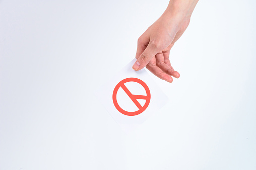 A hand holding a ballot to hold an election.