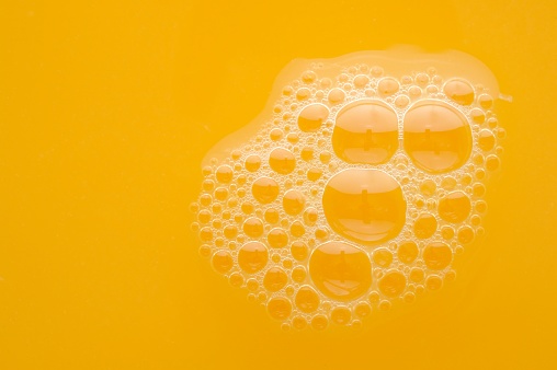 Freshly squeezed orange juice with bubbles close-up