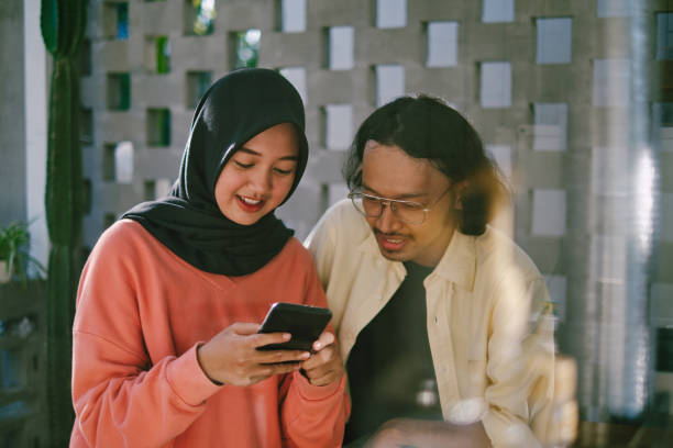 istock Two young people socialising at home 1363229836