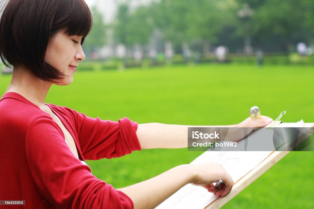 young woman painting a young asian woman is painting, Drawing - Activity Stock Photo