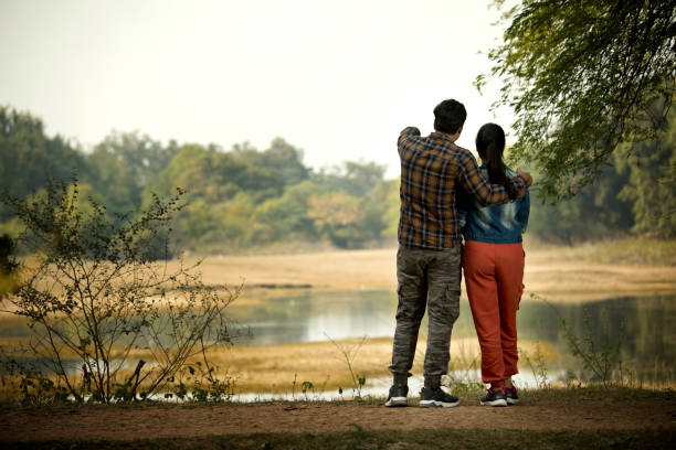 istock Couple admiring view at riverbank 1363232639