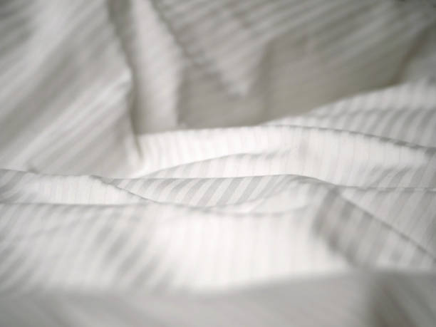 istock Hotel bed white sheets detail 1363233515