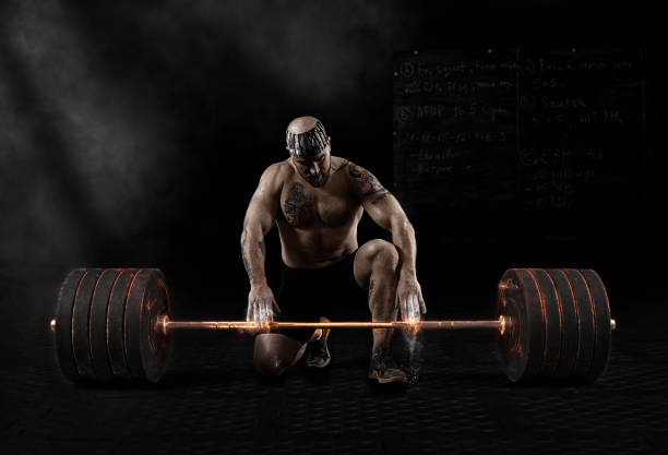 istock Muscular man workout with barbell at gym 1363233669