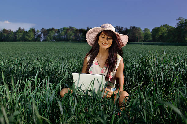 Woman working with a laptop outdoor stock photo