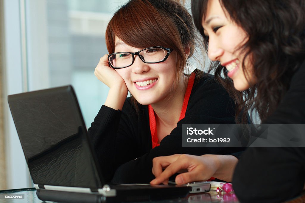 two asian students two asian students are looking at their computer 18-19 Years Stock Photo