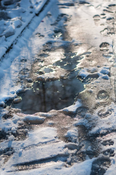 istock Melting snow on a sidewalk in early spring 1363235296
