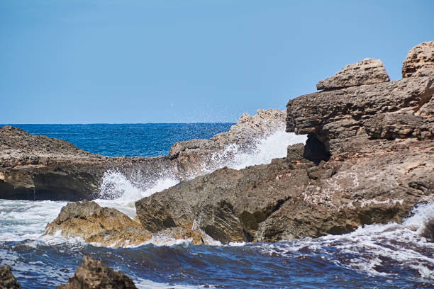 istock Rocks on the shore hit by the wave 1363235354