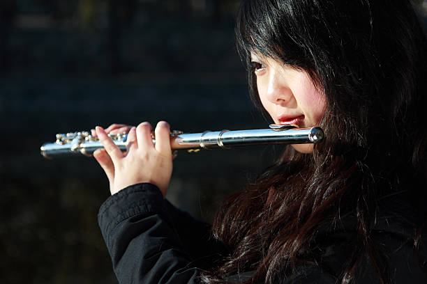 picture of a young girl   playing flute