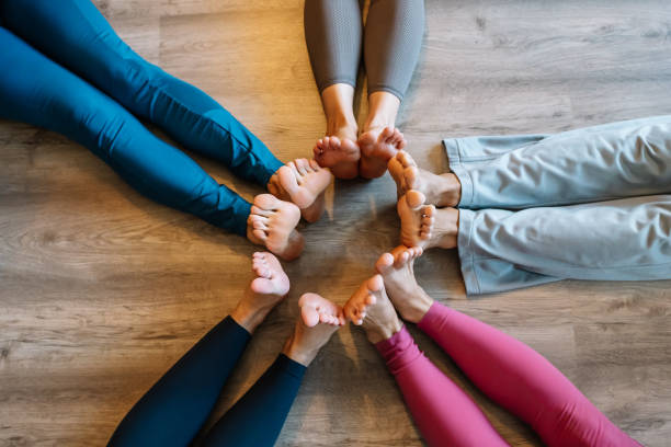 istock Barefoot people joining feet in circle 1363236569