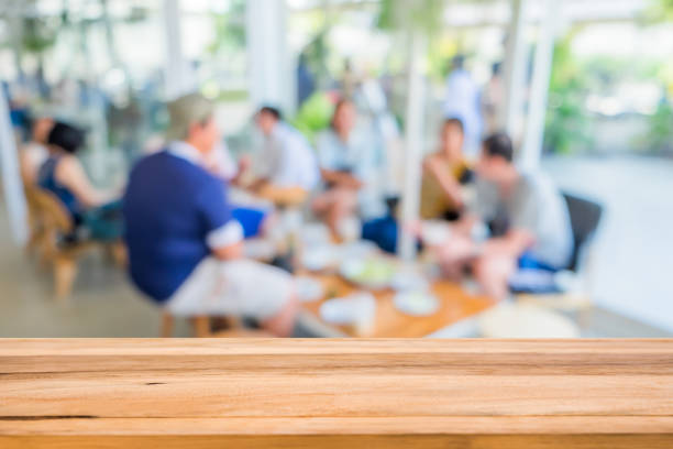 istock Image of wood table in front with blurred background of restaurant 1363236971