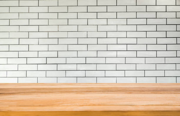 istock Wood table in front of white brick wall background 1363236981